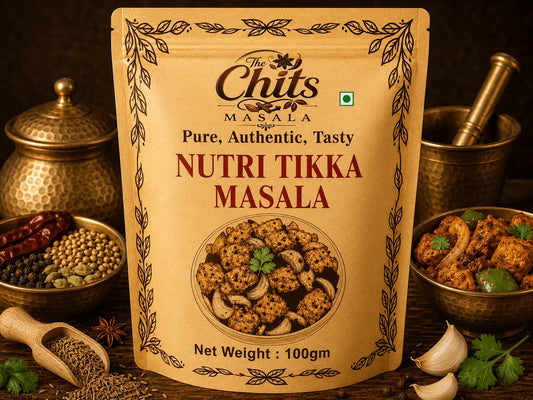 A 100g stand-up pouch of 'The Chits Masala Nutri Tikka Masala' centered on a rustic wooden table surrounded by ingredients and cooking vessels, including bowls of spices, garlic cloves, cilantro, and a brass mortar and pestle.