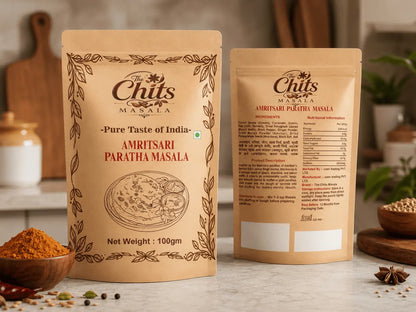 Two stand-up pouches of Chits Masala Amritsari Paratha Masala spice mix displayed on a kitchen counter with bowls of spices and ingredients in the background.